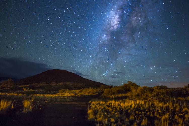 a starry night over Mauna Kea volcano